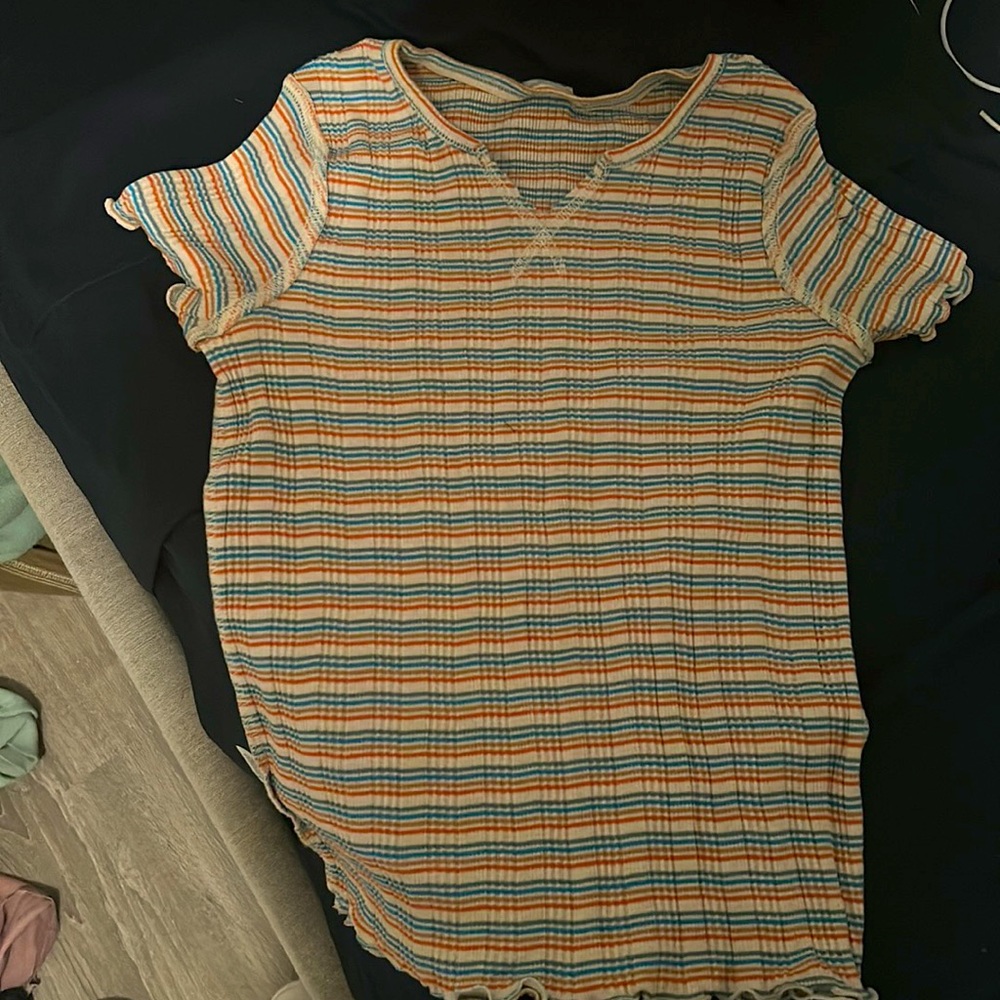 Selling rainbow colored top can be worn as a crop.